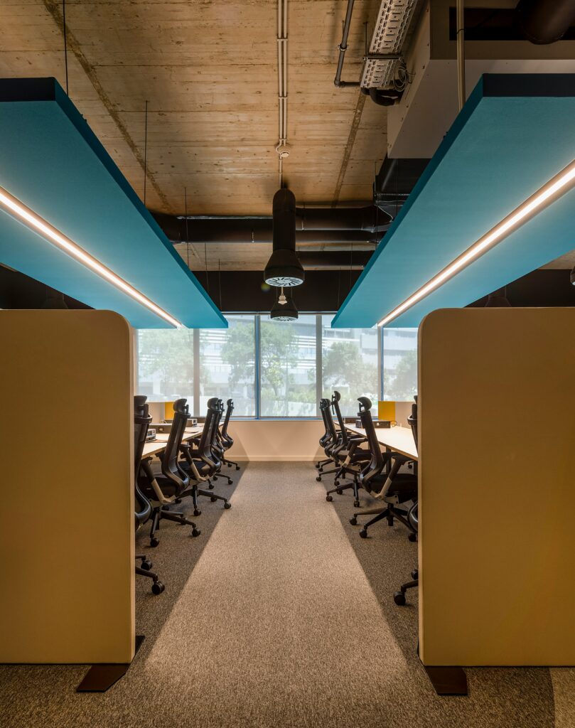 Open workspace featuring modern office furniture with multiple desks and chairs arranged for a productive office environment.