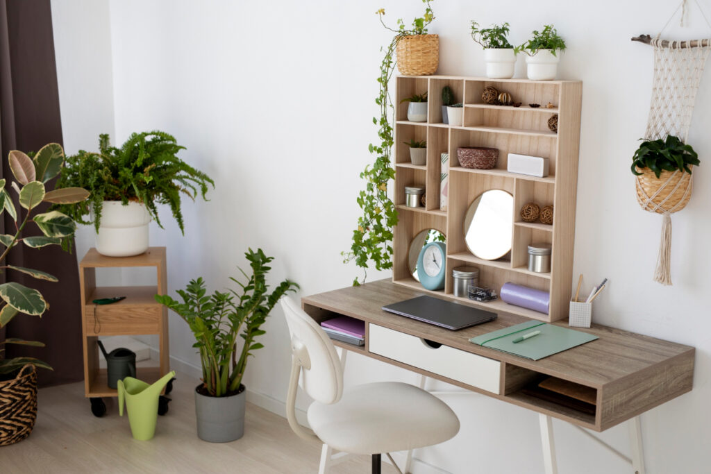 Compact home office setup with modern space-saving furniture, featuring a small desk, ergonomic chair, and wall-mounted shelves in a bright apartment.