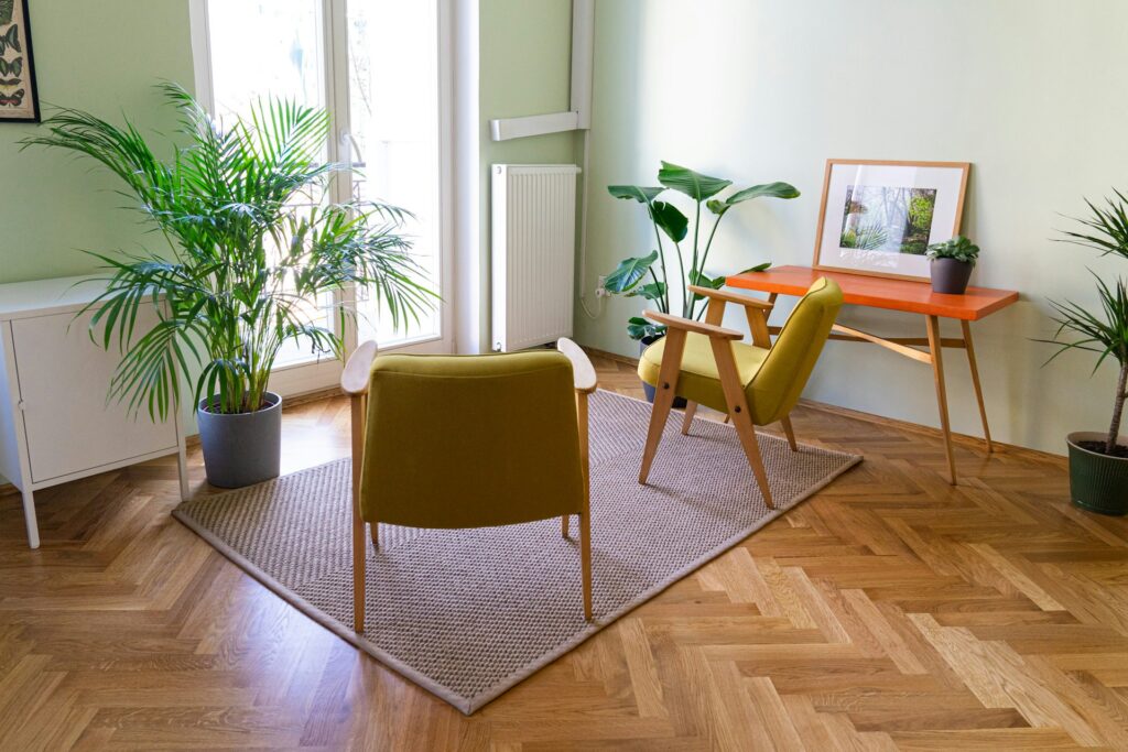 Modern home office with a wooden chair, minimalist desk, and green potted plant creating a natural and eco-friendly workspace ambiance.